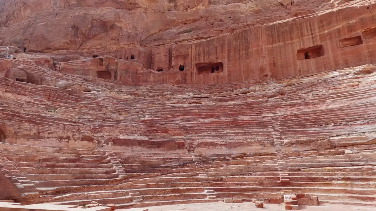 Slowmo panning shot of the ancient ruins of the Amphitheatre in Petra