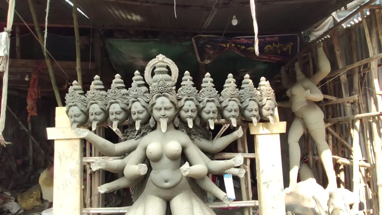 Unfinished clay idols of Indian gods and goddess at workshop smooth camera movement