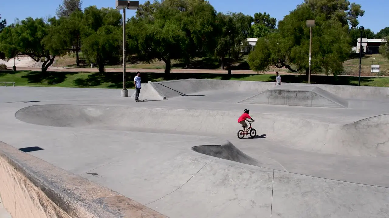 Three generations of skateboarders meet at the lip of the Wedge Skate Park Eldorado Park Scottsdale Arizona