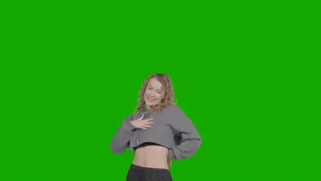 Studio Shot Of Young Woman Having Fun Dancing Against Green Screen 14