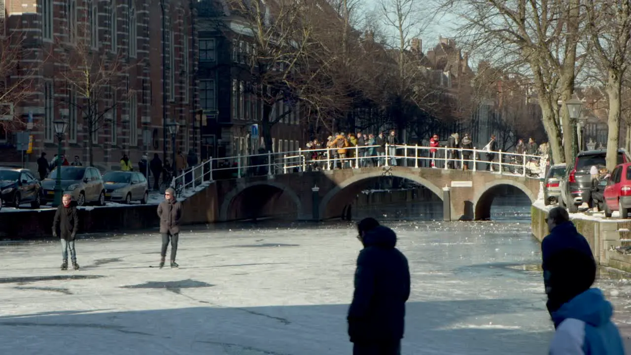 People ice skating on the famous Rapenburg canal in Leiden the Netherlands during the pandemic