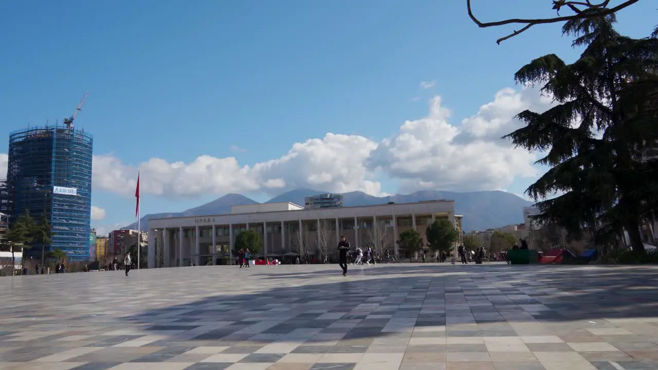 Main square of city paved with multicolored marble tiles and new high buildings background in Tirana Albania