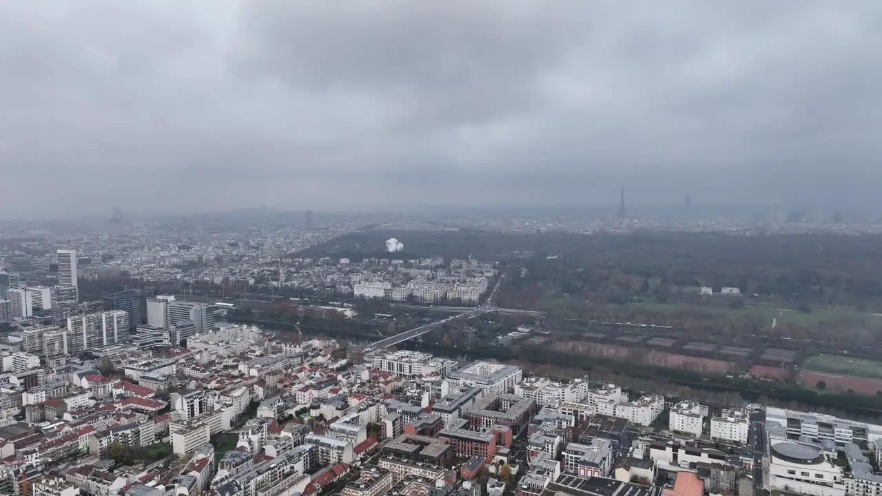 The city's modern skyline in La Défense seen from a cloudy altitude