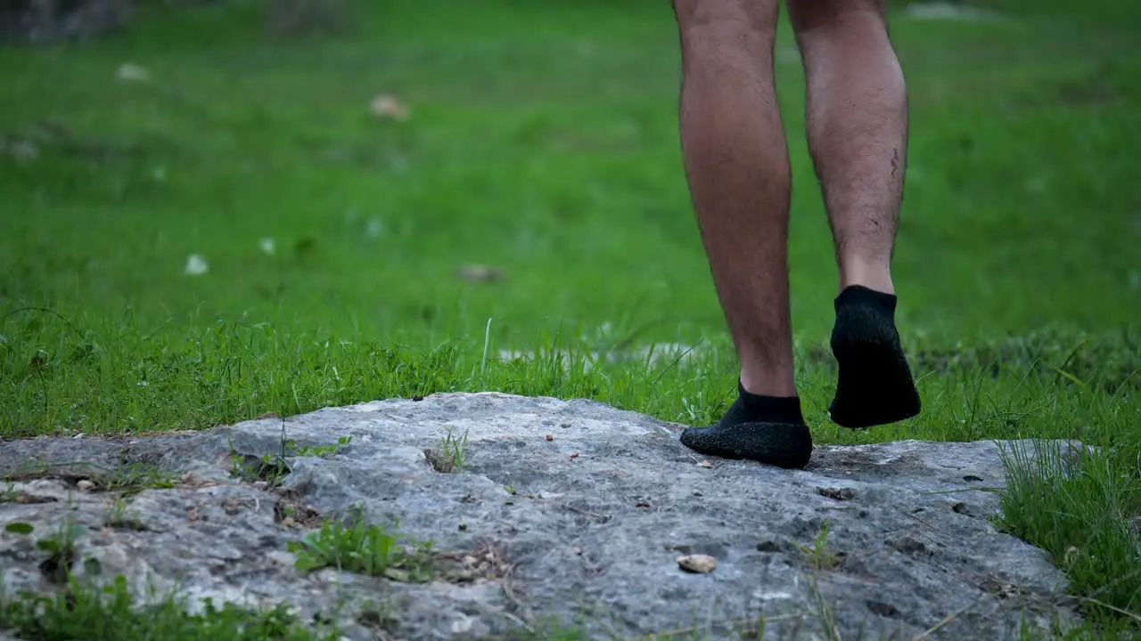 Man Stretches Ankle After Running