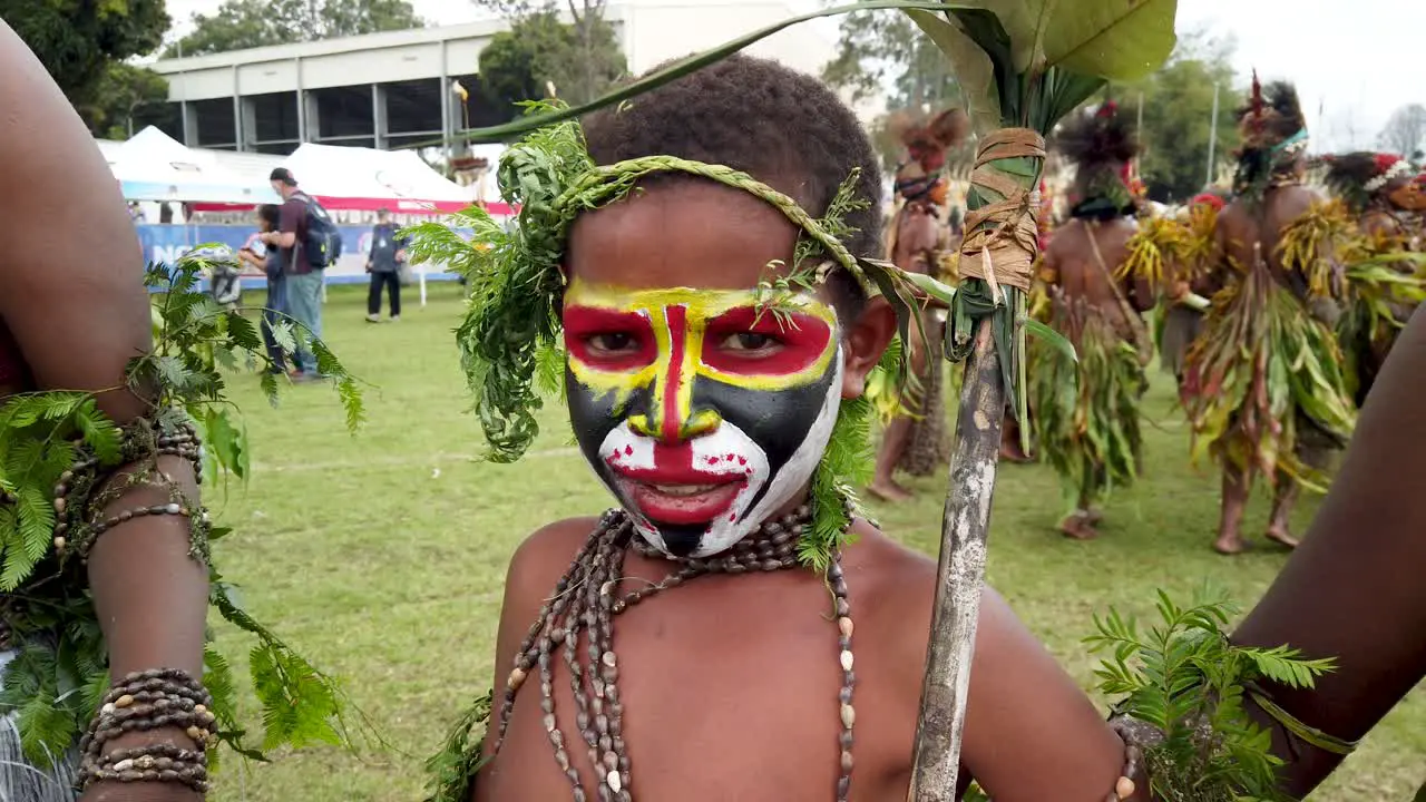 Portrait of happy Papua New Guinea boy in face paint slow motion