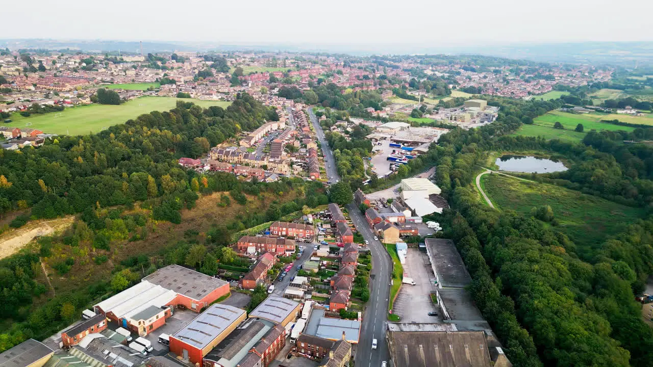 Explore the fame of Dewsbury Moore Council estate through stunning drone-captured aerial footage highlighting typical UK urban housing red-brick terraced homes and the industrial Yorkshire vista