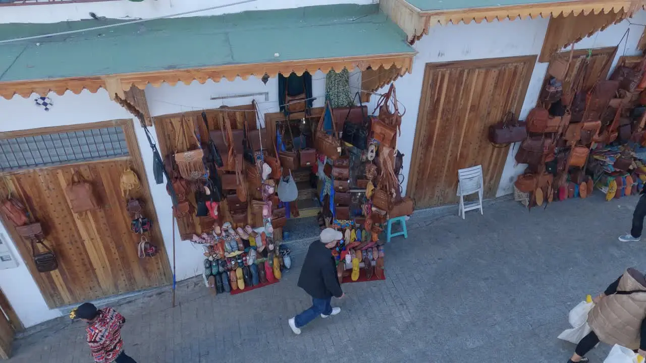 Tangier souvenir shops in the Medina People walking down the street Pan shot