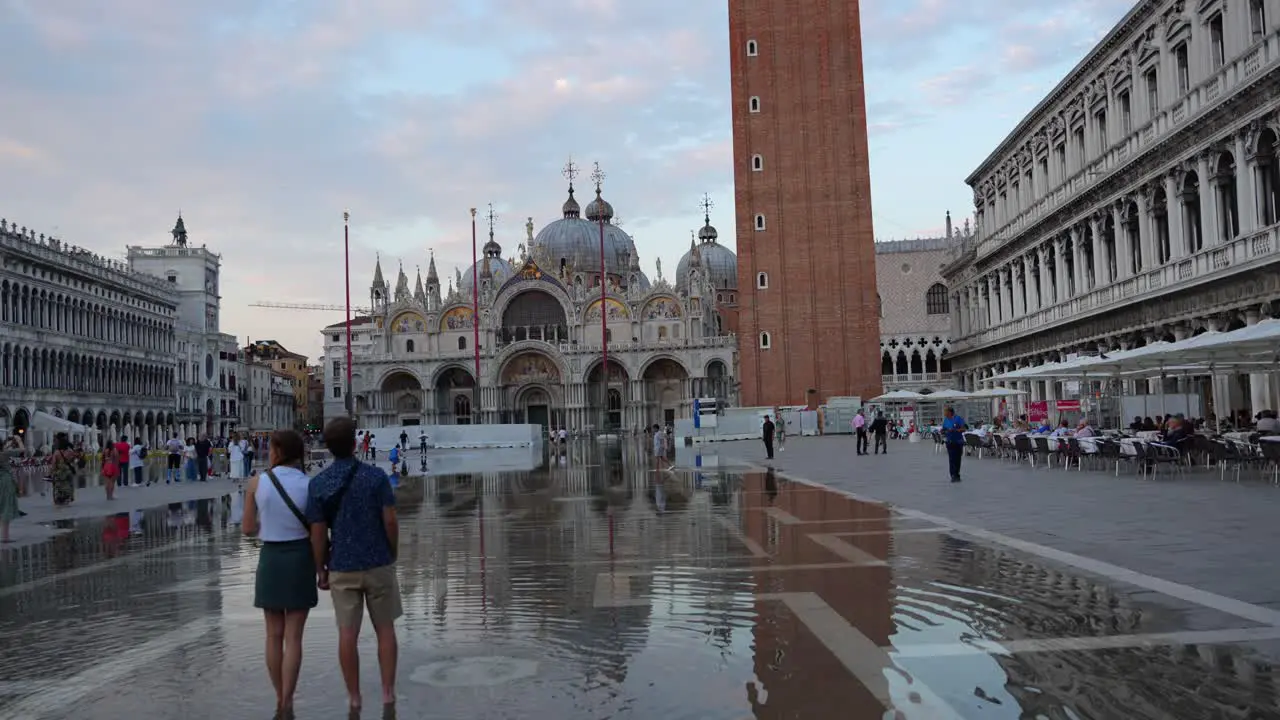 Lovely couple view Basilica di San Marco during Aqua Alta