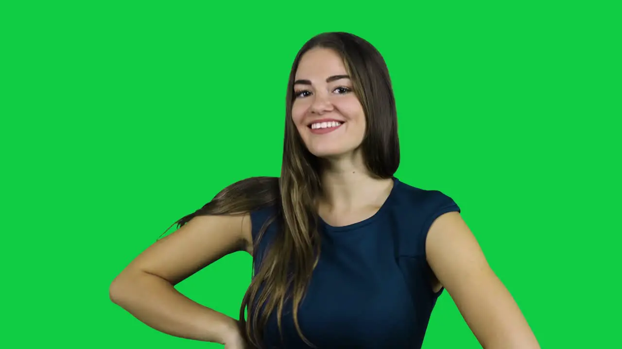 Happy smiling flirty girl in front of a green screen