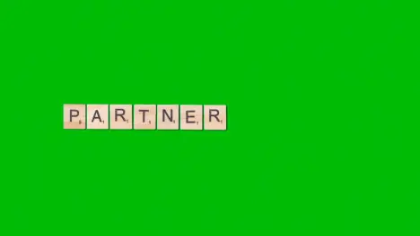 Stop Motion Business Concept Overhead Wooden Letter Tiles Forming Word Partner On Green Screen 1