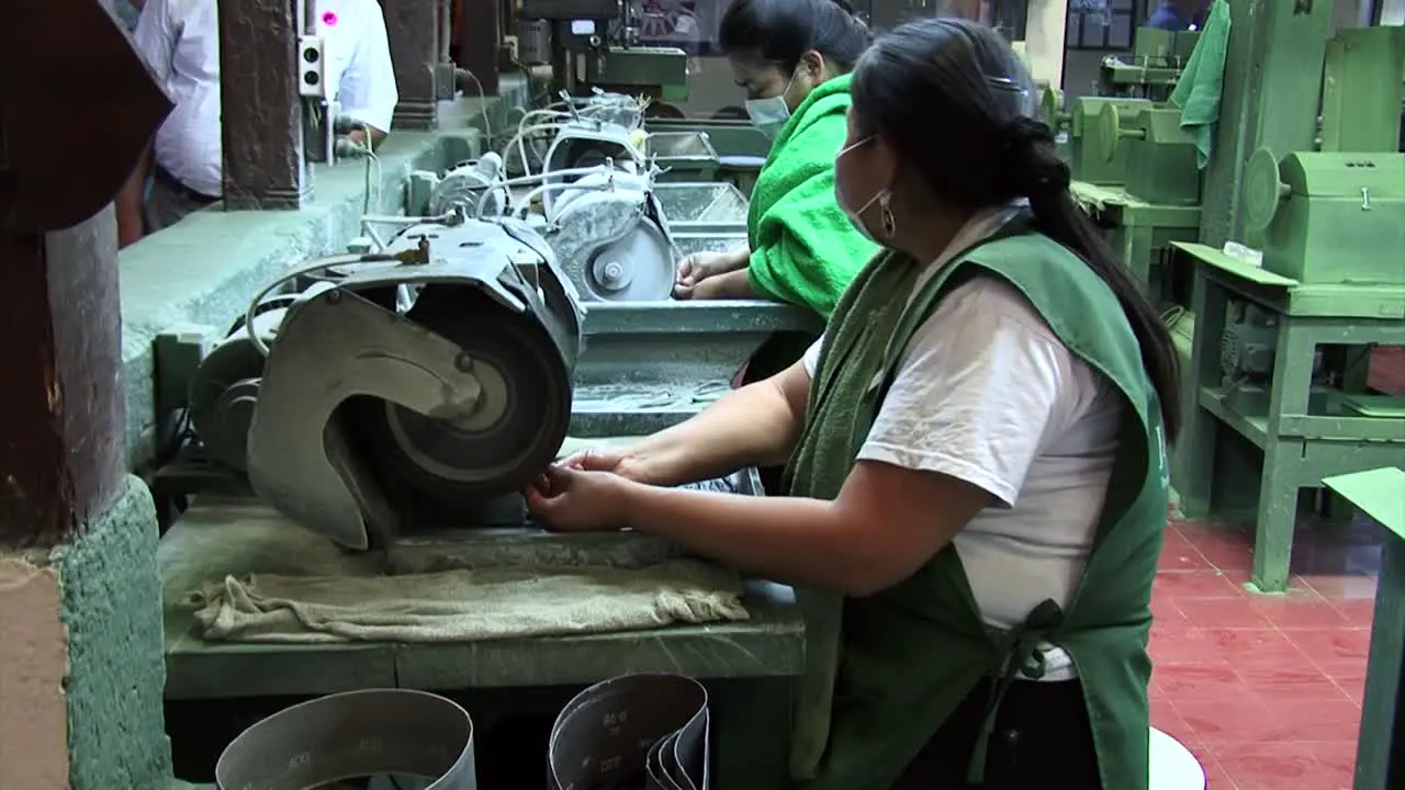 Jade jewellery manufacture worker grinding a jade gemstone Jade Factory Antigua Guatemala Central America