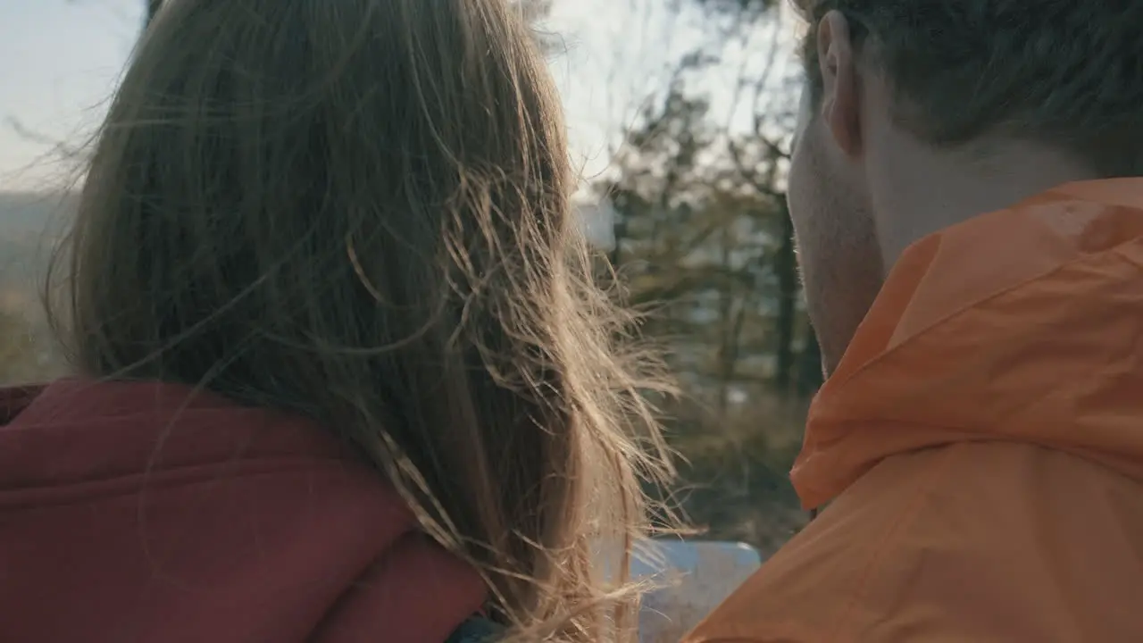  Young female and male hikers looking at a map