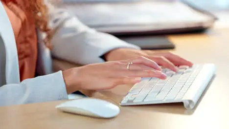 Closeup of the hands of a business woman typing