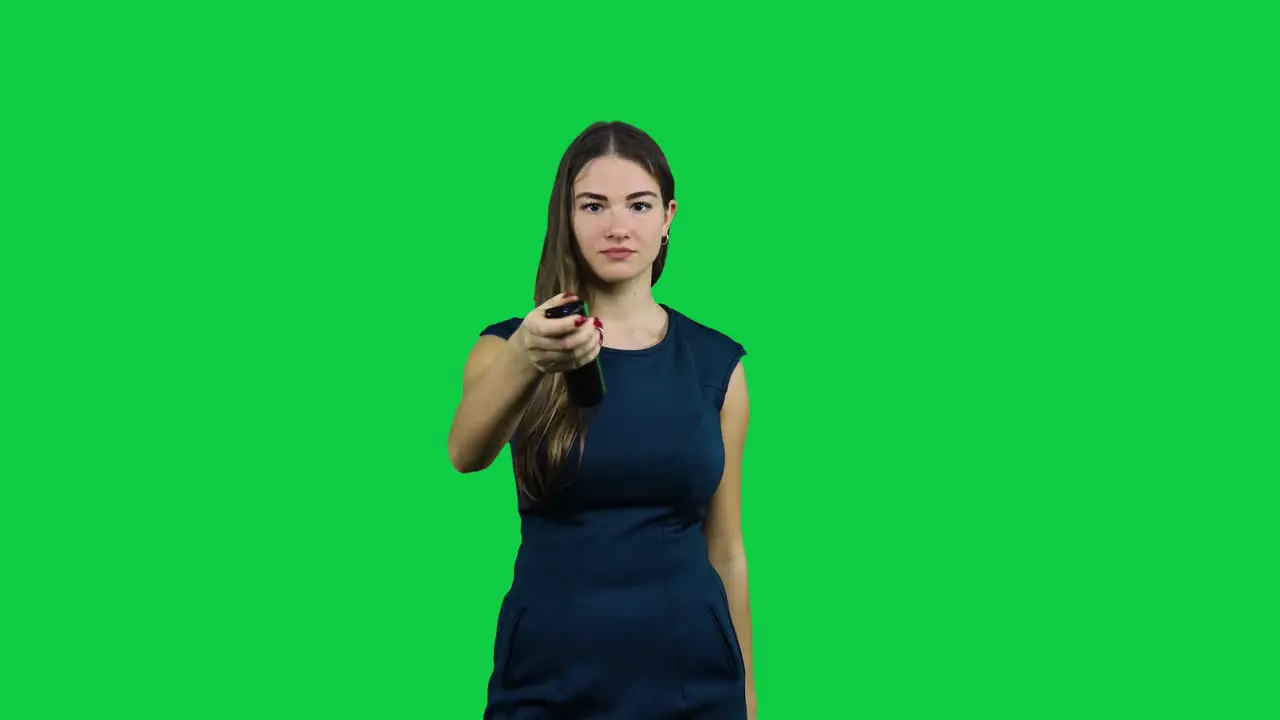 Girl usees a broken TV remote in front of a green screen