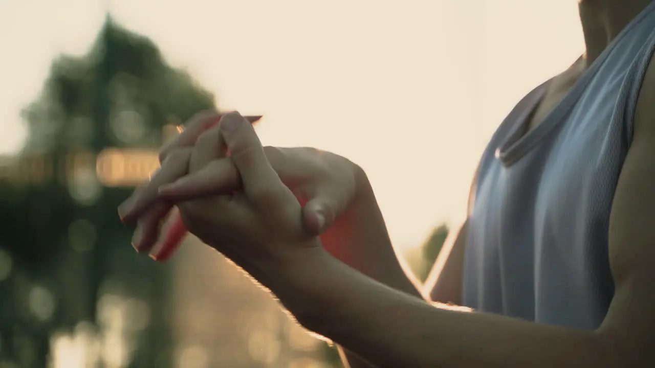 Close Up Of A Sportsman Stretching Wrists And Hands