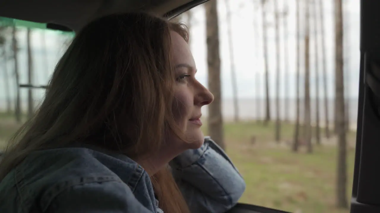 Red Haired Woman Enjoys A Drive Through The Countryside Next To The Lake 1