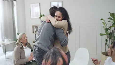 Two people hugging and making peace during