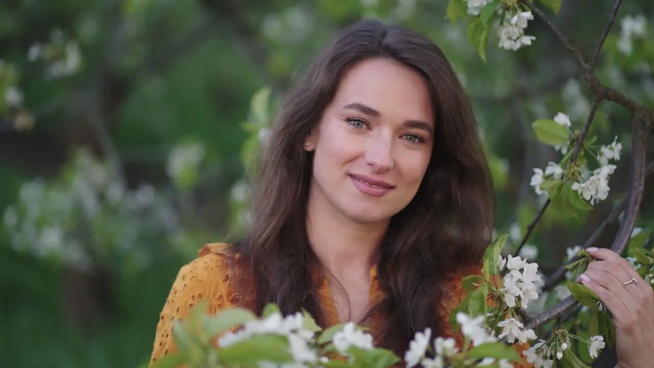 tender and innocent woman in blooming garden portarit of pretty lady in orchard in spring day