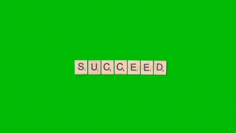 Stop Motion Business Concept Overhead Wooden Letter Tiles Forming Word Succeed On Green Screen 1