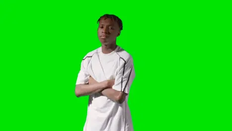 Studio Portrait Of Young Male Footballer Or Sportsperson Wearing Club Kit Against Green Screen 2