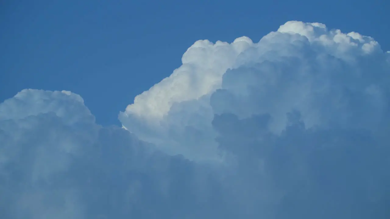 A timelapse of puffy white clouds passing by and morphing quickly