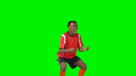 Portrait Of Young Male Footballer Wearing Club Kit Celebrating Goal Against Green Screen 4