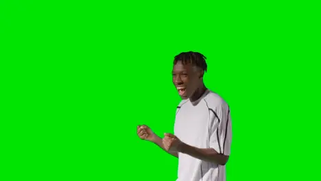 Portrait Of Young Male Footballer Wearing Club Kit Celebrating Goal Against Green Screen 5