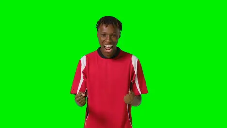 Studio Portrait Of Young Male Footballer Wearing Club Kit