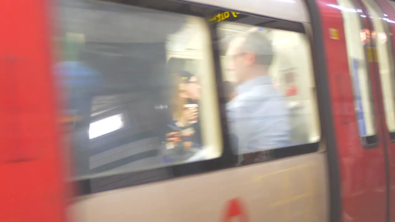 Passengers On The Platform At London Underground With Train Arriving In London UK