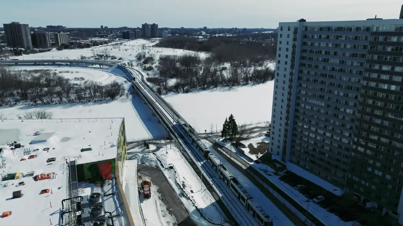 Drone shot train travelling through Ottawa city in Canada in winter snow