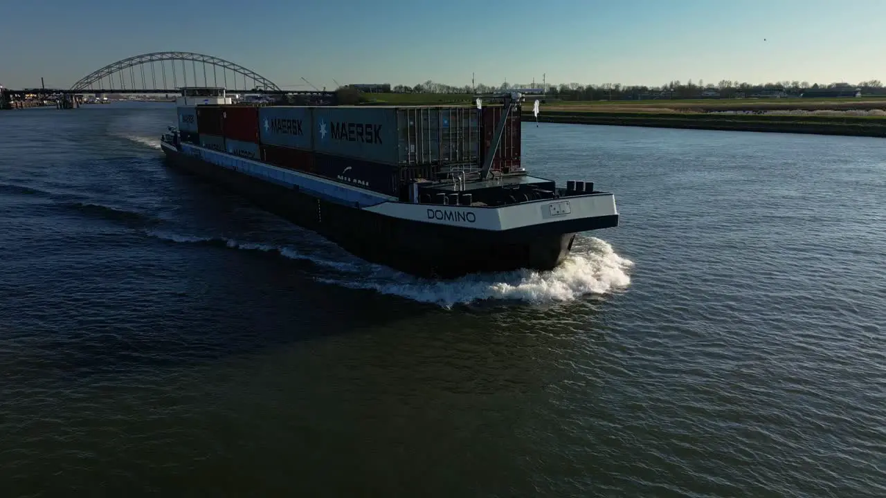 Container ship Domino navigating through the wide canal of Alblasserdam aerial view