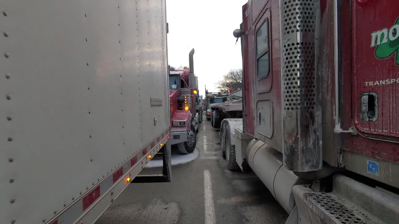 Freedom convoy protest Walking Between rows of trucks on street blockage Tracking shot