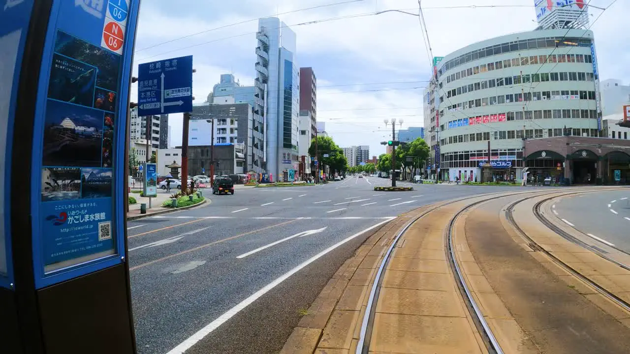 Tram driving through Kagoshima city in Japan POV shot from front