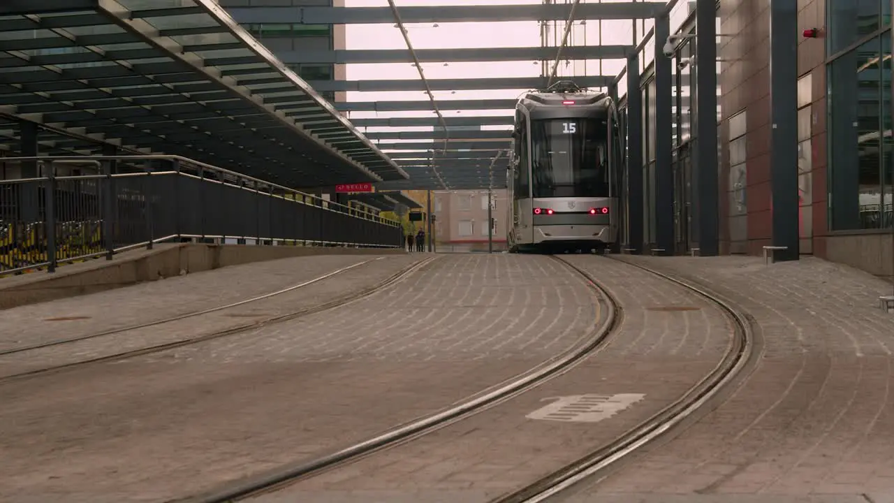 Public transit Modern passenger train stops on quiet city street