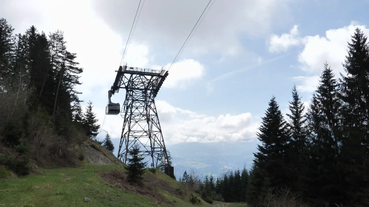 Static low angle shot of Nordkette Cable Car system gondola lift passing by