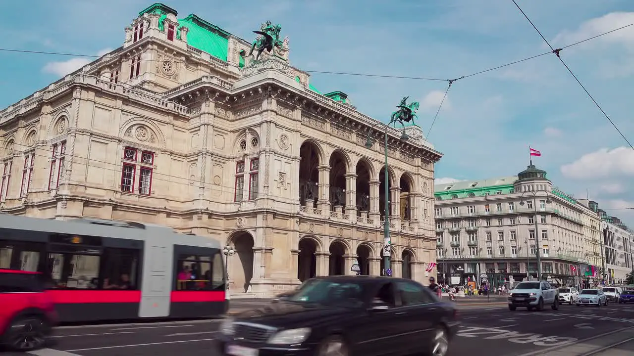 Tram and cars driving by on the Opernring outside Vienna State Opera in the city center of Vienna