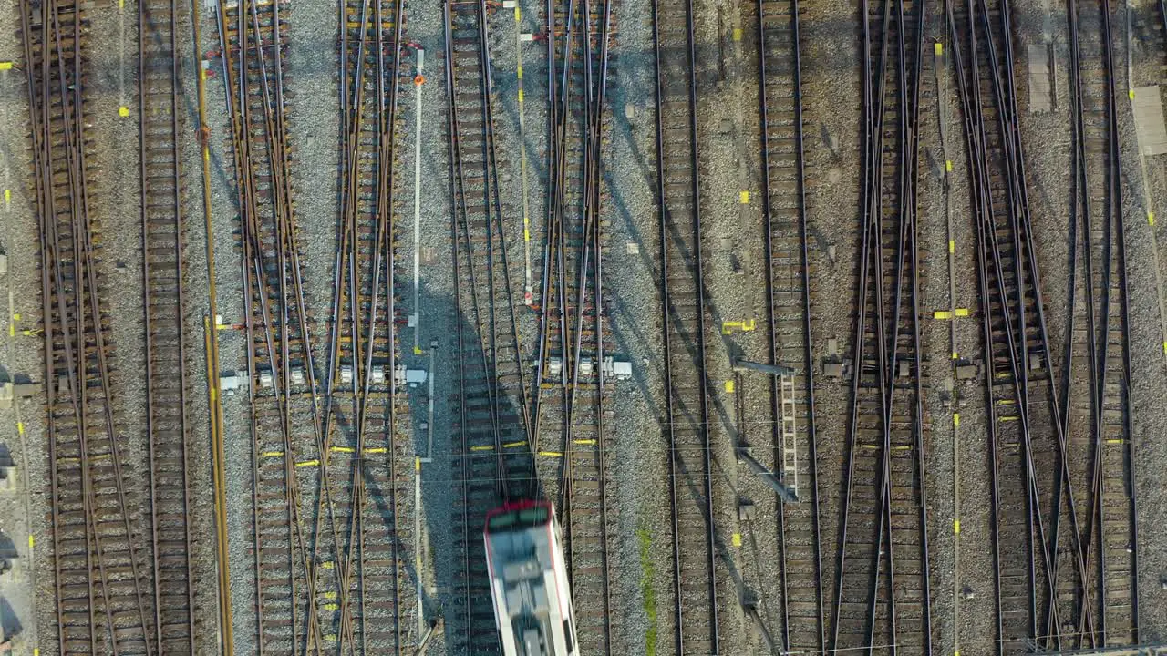 Top Down Aerial View of Train on One of Many Tracks in Central Station