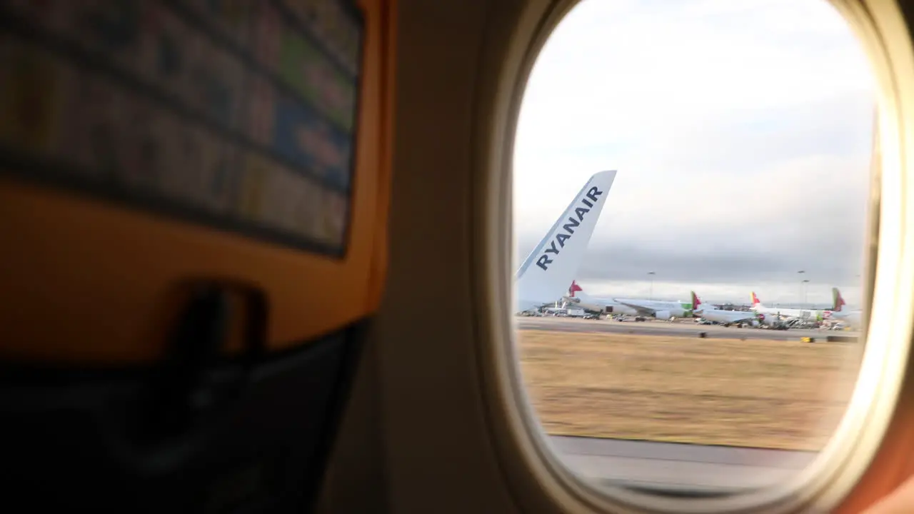 Aircraft Wing Window View While Airplane Taking Off From Lisbon Airport POV