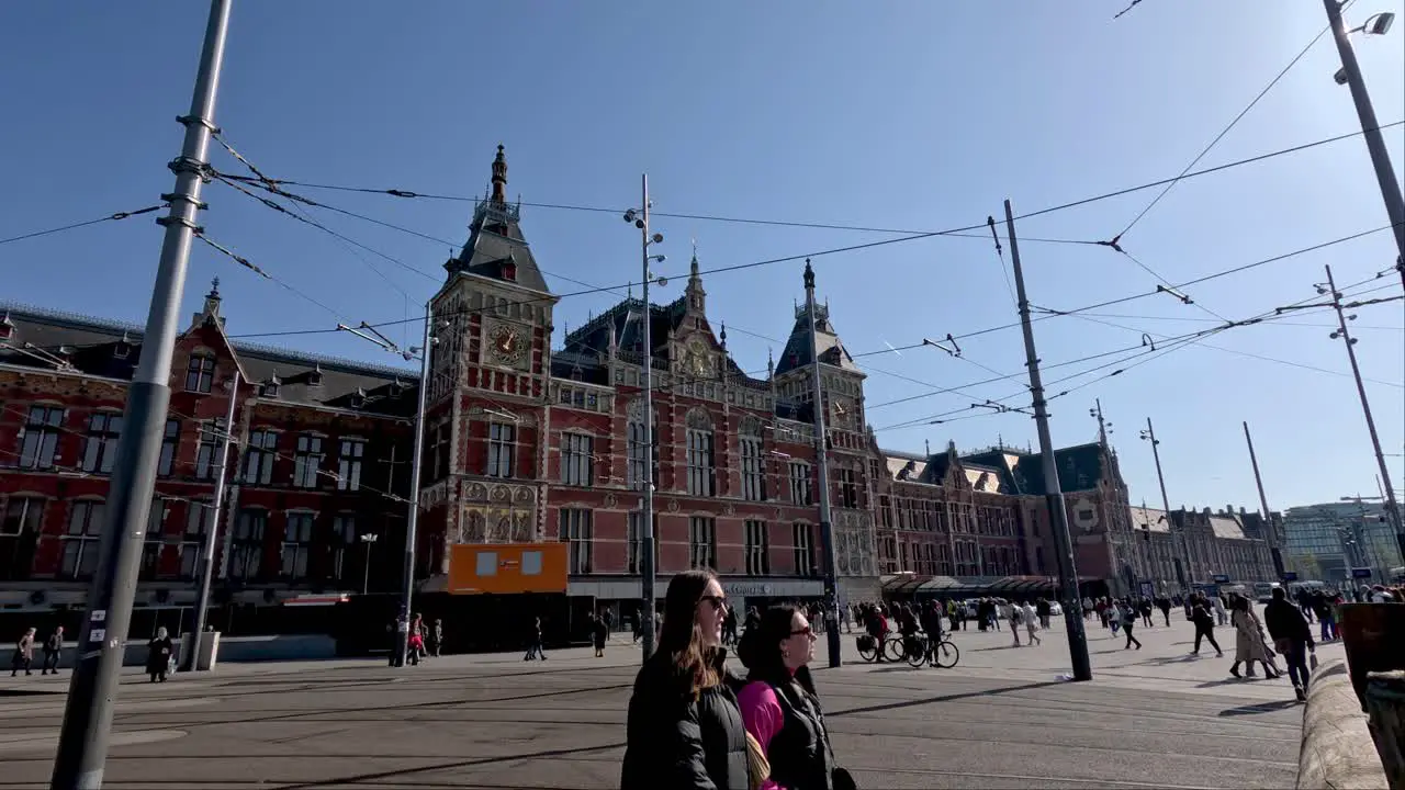 Wide view of entrance to central station pedestrians passing by