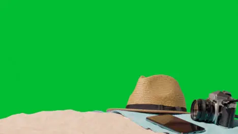 Summer Holiday Concept Of Camera Sun Hat Mobile Phone Beach Towel On Sand Against Green Screen 5