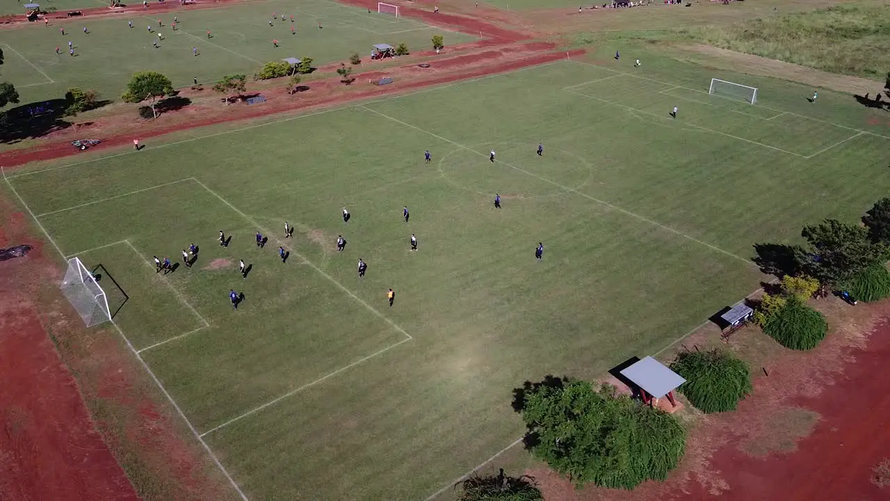 Slow drone strafe following football match and goal being scorred