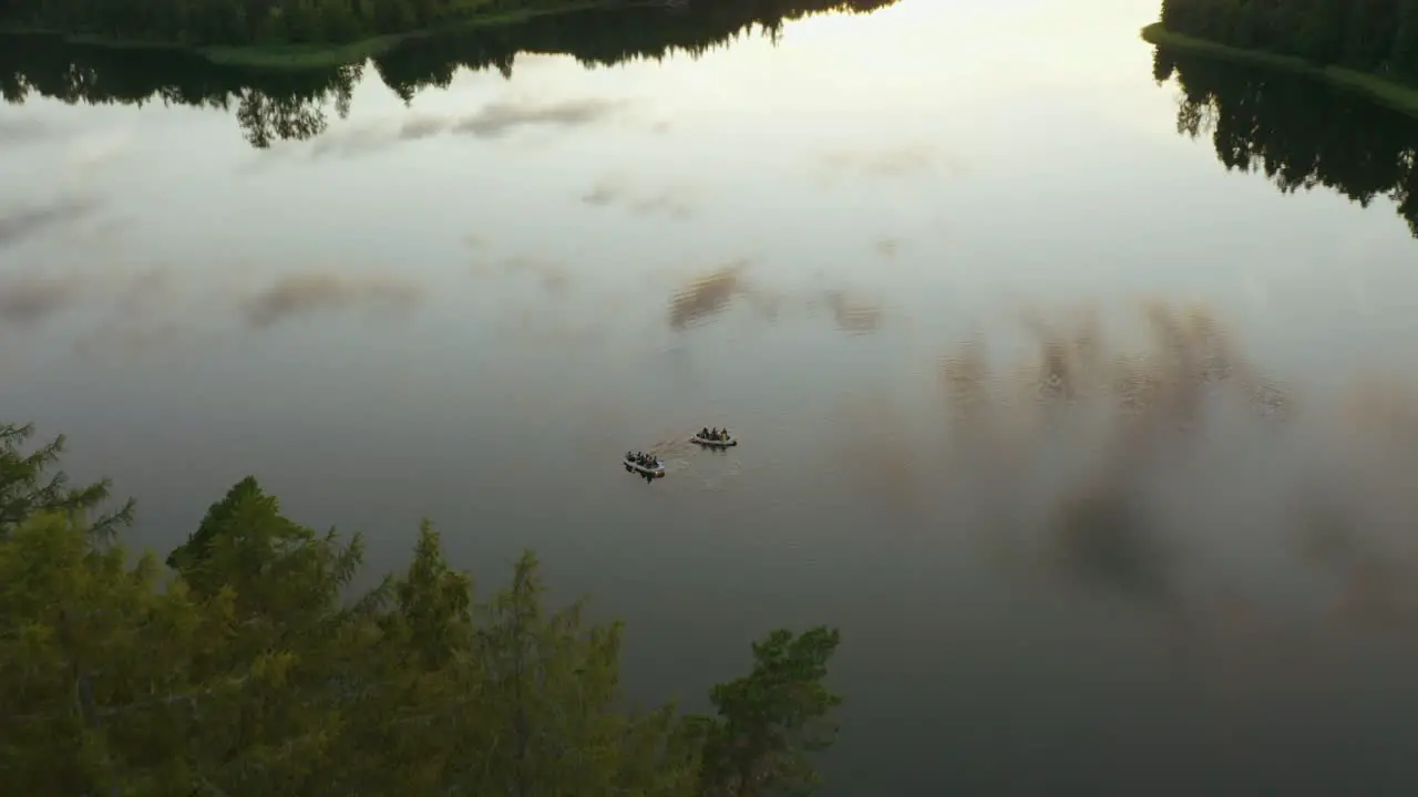 Group of people with two boats on a journey on the lake