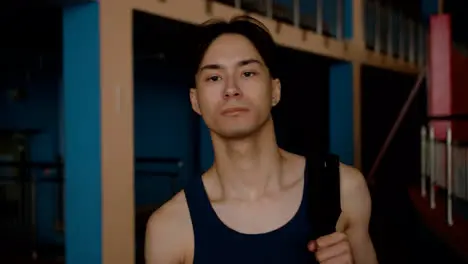 Young man with backpack at the gym