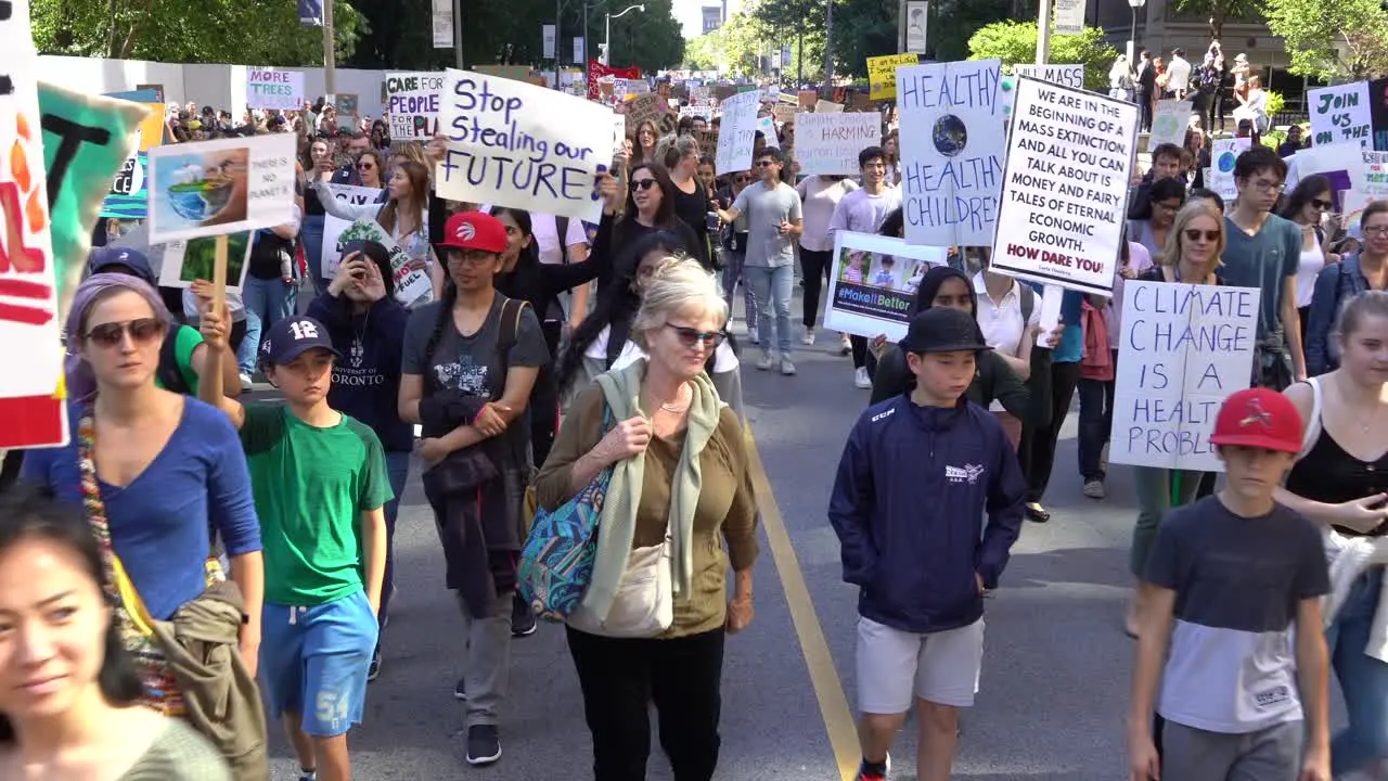 Crowd marching in street against climate change