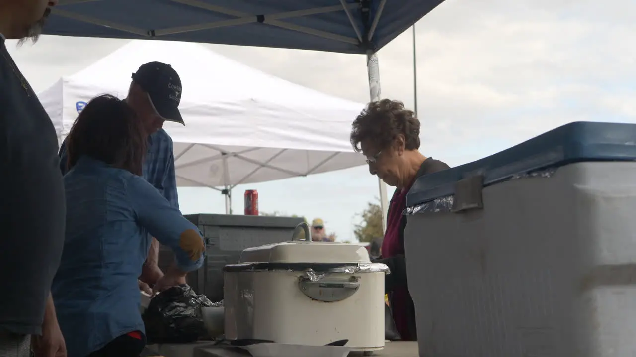 An old woman getting a plate of BBQ at a local fundraiser