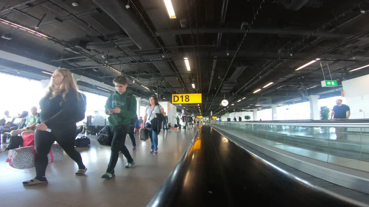 People traveling with luggage inside an airport