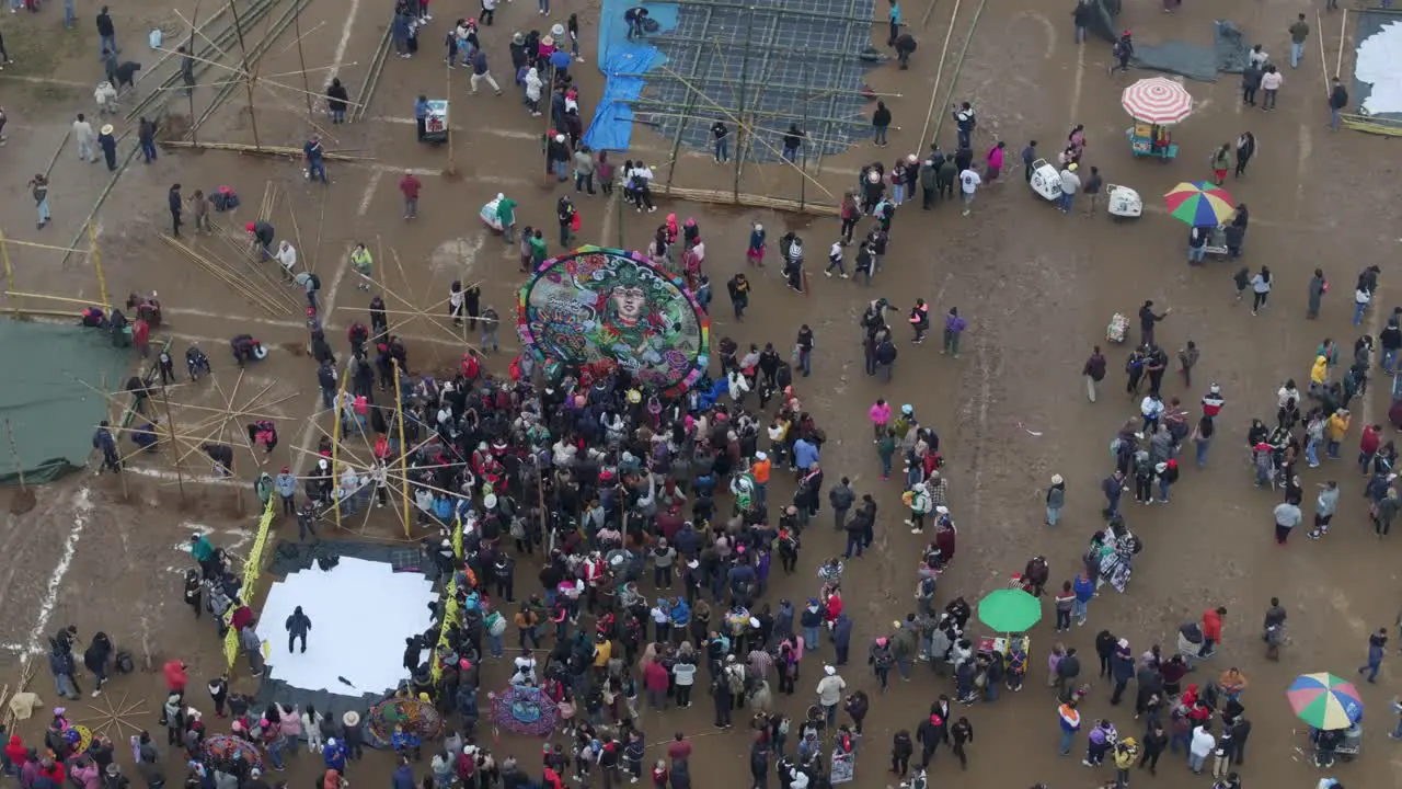 Big group of people in front of giant kite at Sumpango Kite Festival aerial