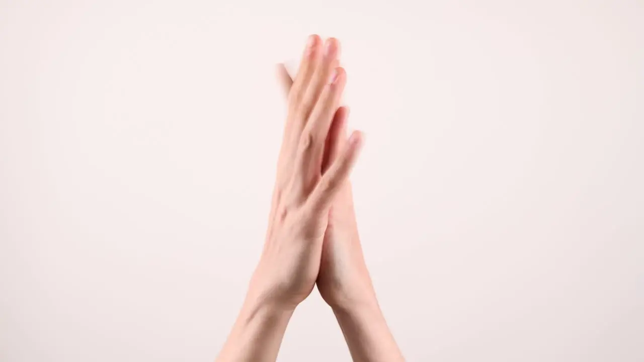 A pair of hands clapping flat in the middle