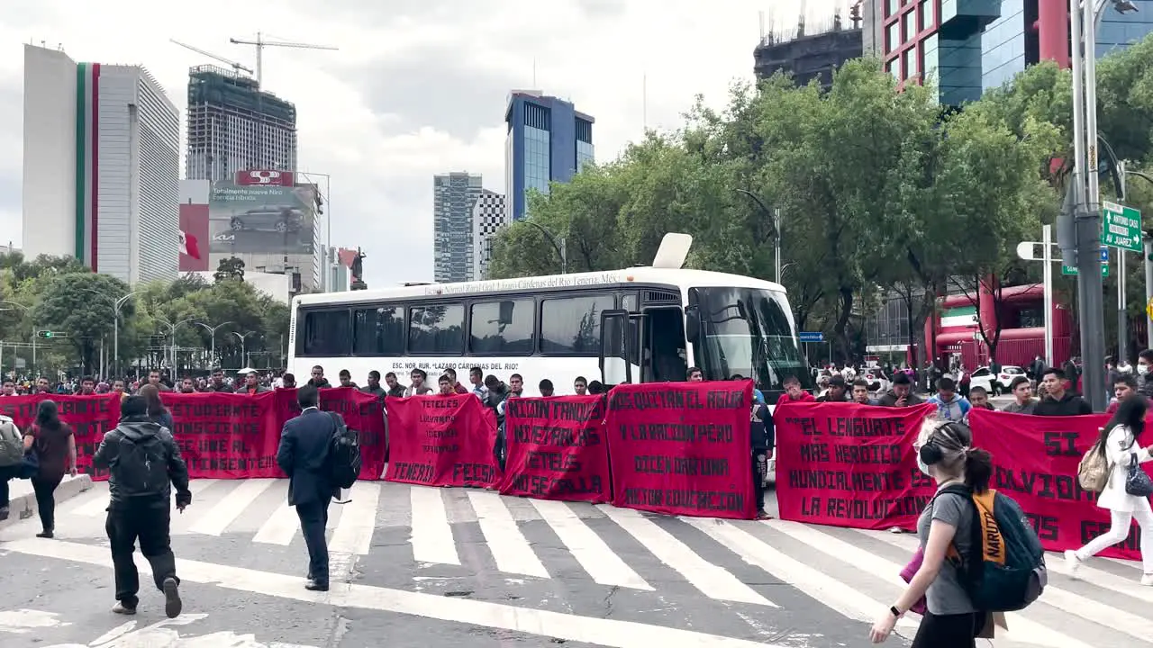 frontal shot of students blocking Reforma avenue of mexico city in demonstration