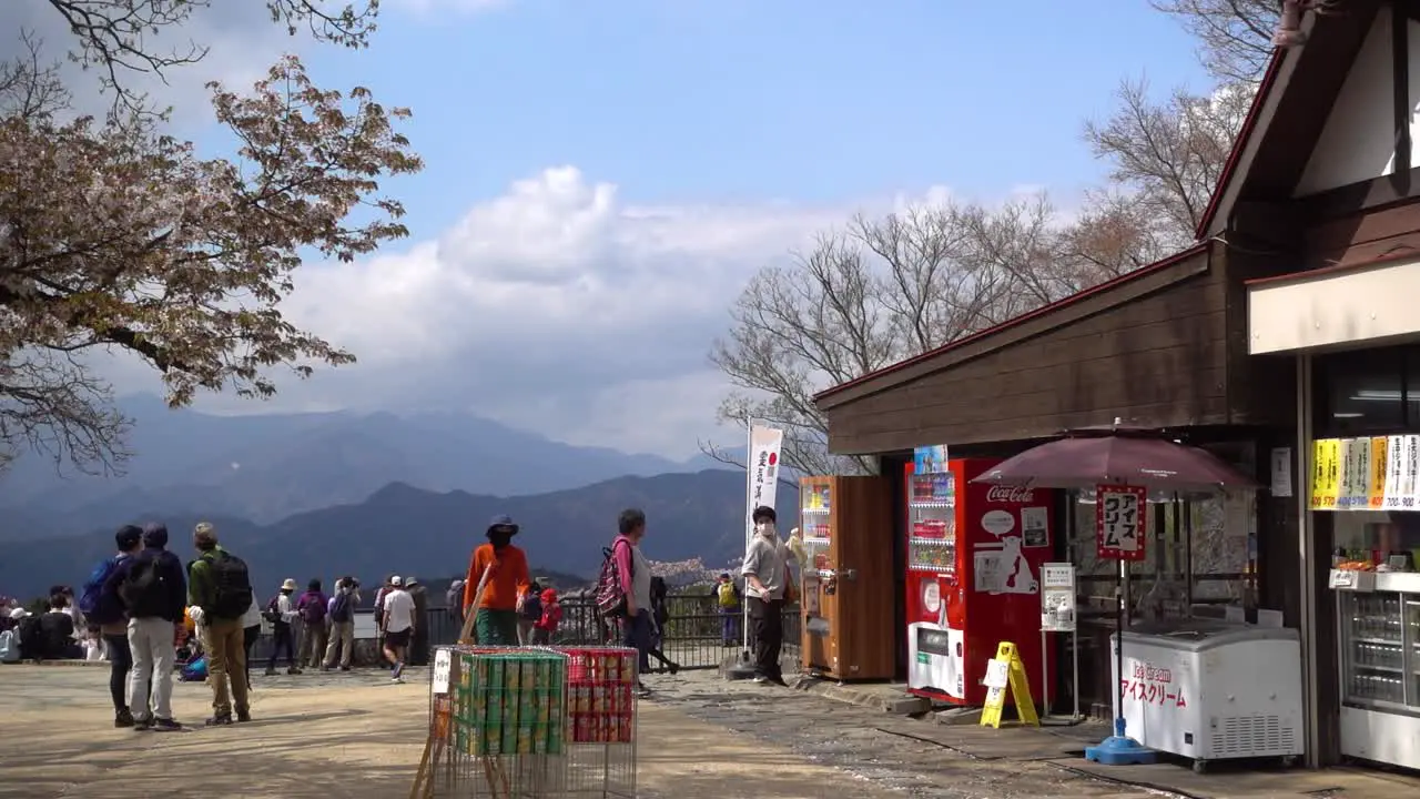 Beautiful view on top of Mount Takao with many hikers on clear blue sky day